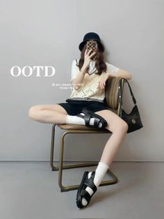 Woman in a bucket hat and crochet vest sitting on a chair indoors