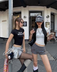 Two women in street style outfits posing outdoors