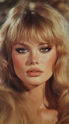 Woman with blonde hair and dramatic eye makeup in a close-up portrait