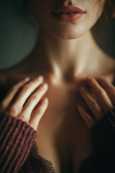 Upper body shot of a woman with exposed skin, cleavage, and hands on her chest