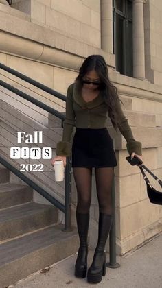 Woman in a cropped cardigan and mini skirt with platform boots outdoors
