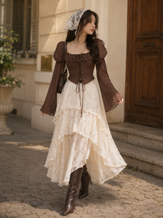 Woman in a brown corset top and tiered lace skirt with a white lace scarf