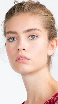 Close-up portrait of a woman with blonde hair and blue eyes