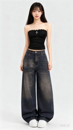 Woman in a black tube top and wide leg jeans on a white background