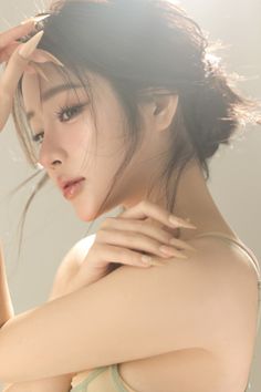 Woman with long hair and long nails in a soft, backlit portrait