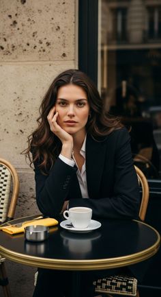 Woman in a black suit jacket and white shirt at an outdoor cafe