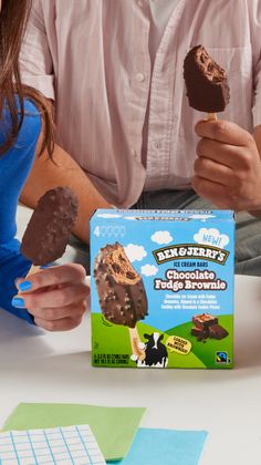 Two people holding Ben & Jerry's Chocolate Fudge Brownie ice cream bars