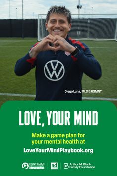 Soccer player with short dyed hair making a heart gesture on a soccer field