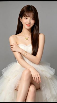 Woman in a white strapless dress with a butterfly necklace and long hair