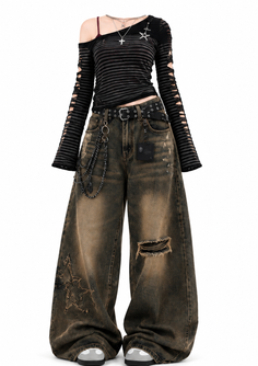 Gothic style outfit with ripped wide-leg jeans and an off-shoulder striped top