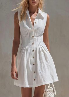 Woman in a white sleeveless collared dress with blonde hair outdoors