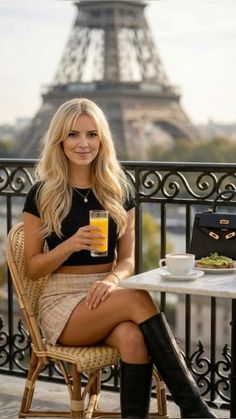 Woman with long blonde hair sitting at an outdoor cafe with the Eiffel Tower in the background