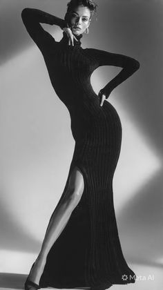 Woman in a black long-sleeve dress with a high slit posing dramatically
