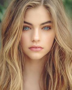 Close-up portrait of a woman with blonde hair and blue eyes