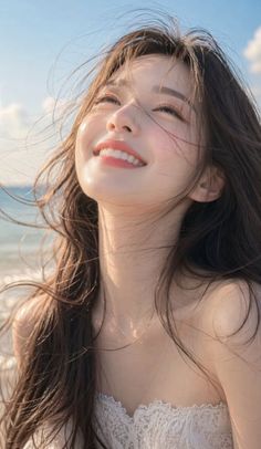 Woman with long hair smiling on a beach with soft lighting
