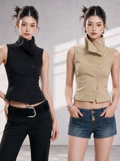 Two women posing in sleeveless tops, one in black pants and the other in denim shorts