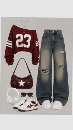 A flat lay of a casual outfit with a cropped sweatshirt and baggy ripped jeans