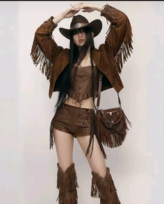 Woman in a brown cowboy outfit with fringe details and a cowboy hat