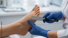 Close up of a person's foot receiving a pedicure with a foot file