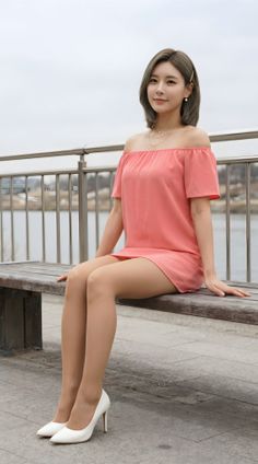 Woman in a pink off-shoulder dress and white heels sitting on a bench outdoors