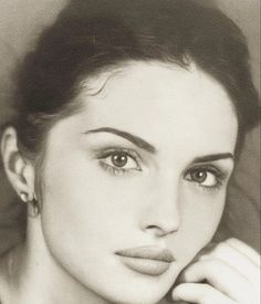 Pencil drawing of a woman with dark hair and an earring, looking directly at the viewer