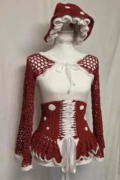 Crochet mushroom-themed outfit with a lace-up corset and shrug on a mannequin