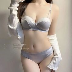 Woman in light gray lingerie with white arm warmers