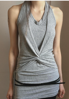 Woman in a gray halter top dress with a black belt