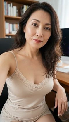 Woman in a lace camisole taking a selfie indoors