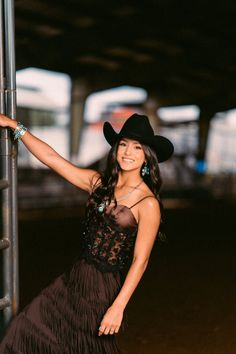 Woman in a cowboy hat and brown fringe dress with turquoise jewelry