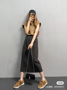 Person in a baseball cap and midi skirt taking a mirror selfie indoors