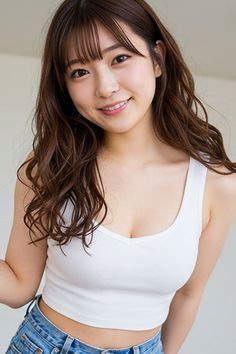 Woman with long brown hair and a white tank top smiling at the camera