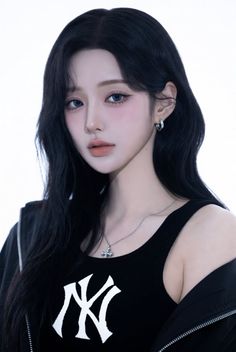 Woman with long black hair and blue eyes wearing a black tank top and silver jewelry