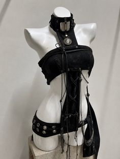 Black gothic-style clothing on a white mannequin in a studio setting