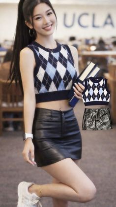 Woman in a crop top and leather skirt holding books indoors
