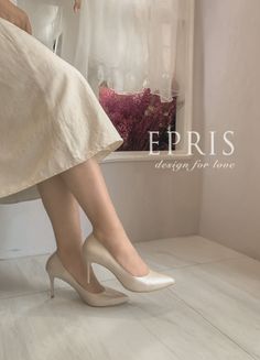Woman wearing beige high heels and a dress indoors