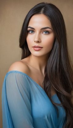 Woman with long dark hair and blue eyes wearing a sheer blue off-shoulder top