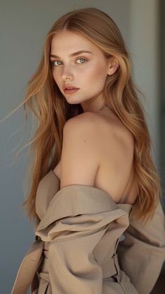 Woman with blonde hair and freckles looking over her shoulder