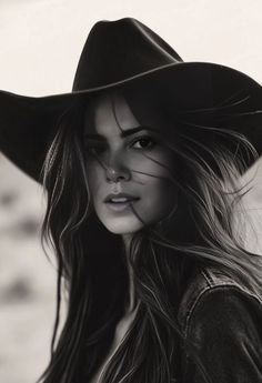 Woman in a cowboy hat and denim jacket in a black and white portrait