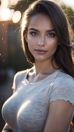 Woman with long hair in a tight t-shirt during golden hour