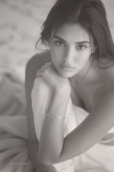 Monochrome portrait of a woman with long hair and a silver bracelet