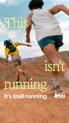 Two people trail running on a desert path under a blue sky