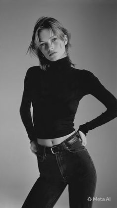 Woman in a black turtleneck and jeans with exposed midriff in a studio