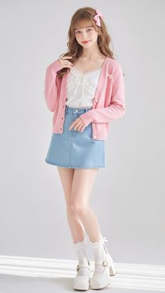 Woman in a pink cardigan and denim skirt with a pink bow in her hair