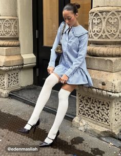 Woman in a striped dress and knee high socks sitting outdoors