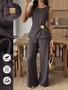 Woman in a dark gray sleeveless top and wide leg pants with a gold buckle