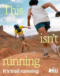Two people trail running on a desert landscape under a blue sky