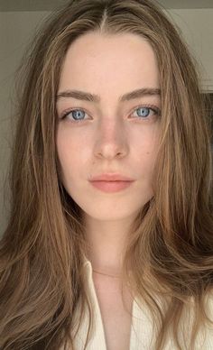 Close up portrait of a woman with blue eyes and long brown hair
