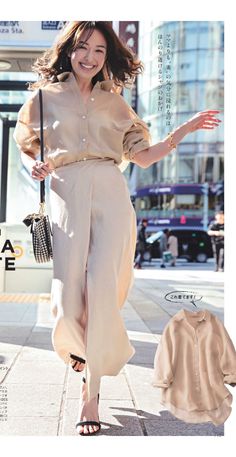 Woman in a sheer beige shirt and wide-leg pants walking on a city street