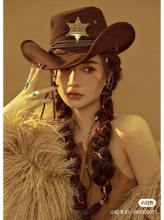Woman in a cowboy hat and fur coat with braided hair and freckles